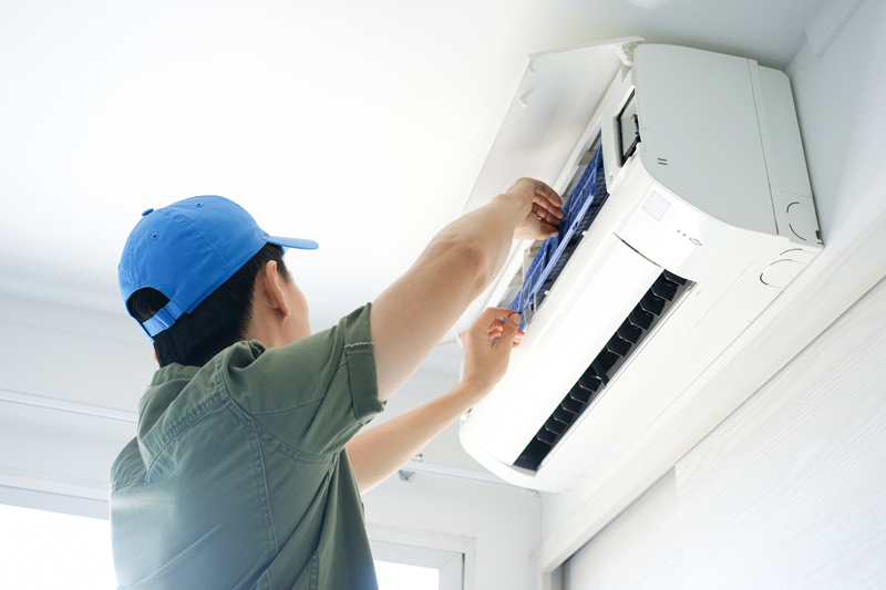 Heat pump being installed on high wall