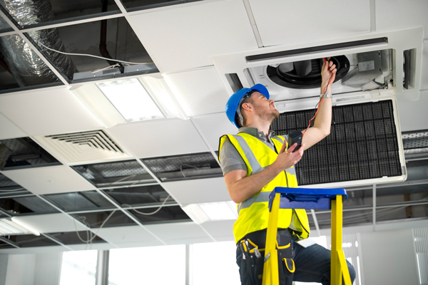 electrician fixing air conditioning